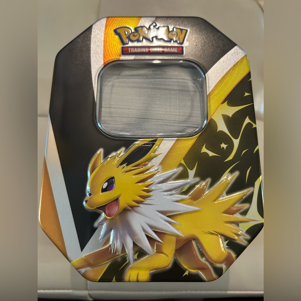 250 Pokémon cards. Unopened energy pack Tin included + 65 card sleeves and more
